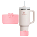 Pink bow silicone base protector and a cream tumbler with the boot on the bottom