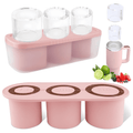 Pink silicone ice cube tray with three clear cylinder ice cubes and a tumbler