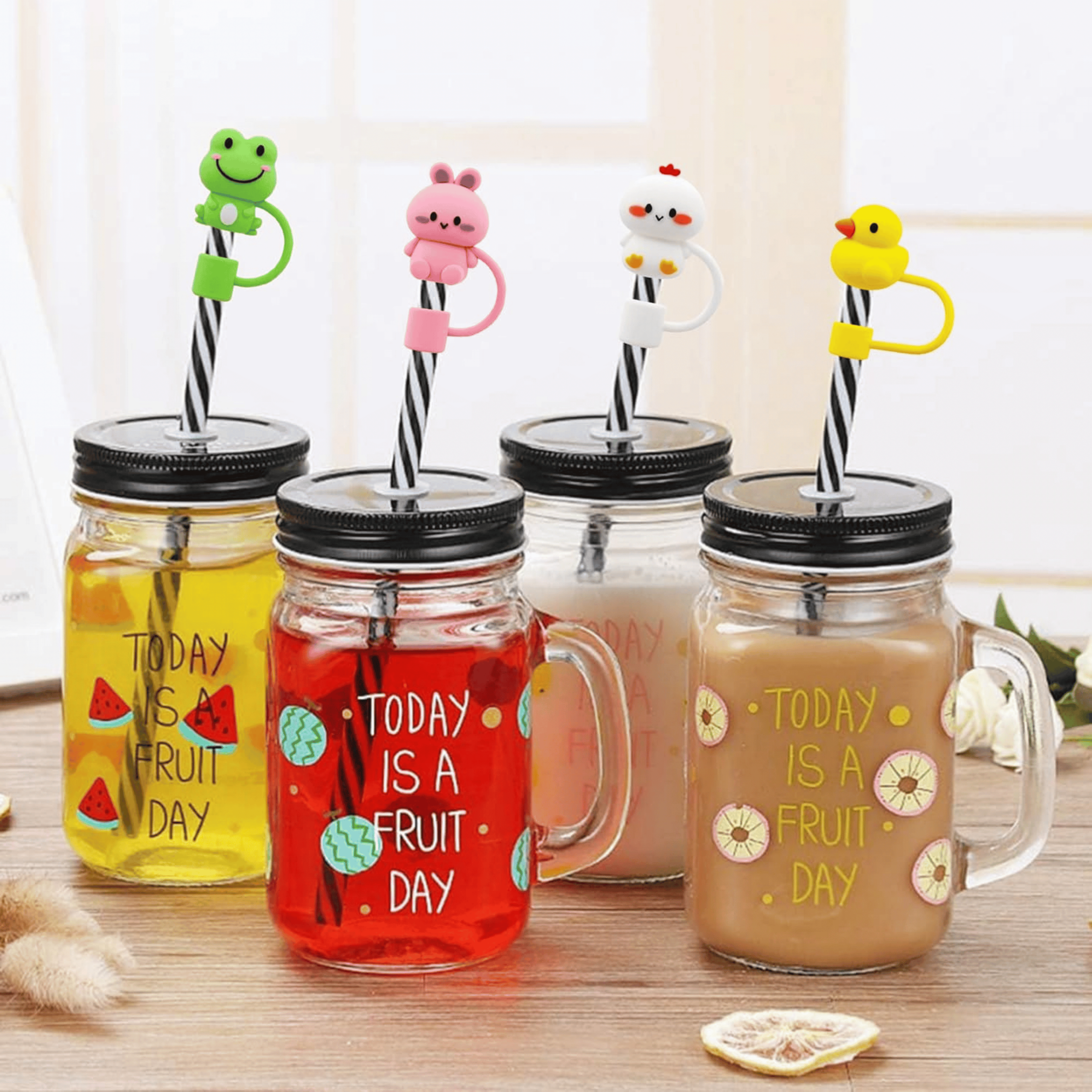 Animal-shaped silicone straw covers on glass mason jars